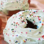 Lucky Baked Sweet Potato Cake Donuts with white frosting and sprinkles