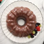 Sweet Potato Chocolate Cake on a plate with fresh fruit
